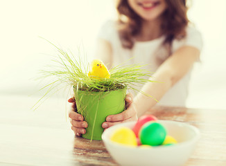 Image showing close up of girl holding pot with green grass