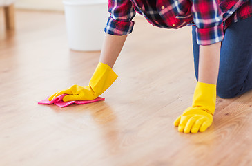 Image showing close up of woman with rag cleaning floor at home