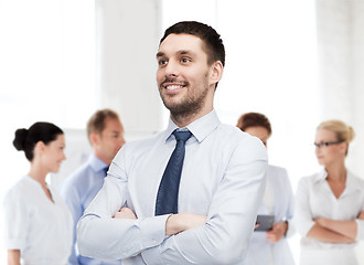 Image showing handsome businessman with crossed arms