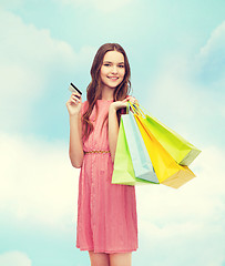 Image showing smiling woman in dress with many shopping bags