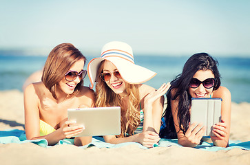 Image showing girls with tablet pc on the beach