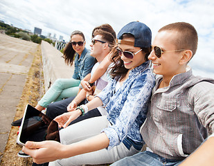 Image showing group of teenagers looking at tablet pc