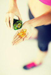 Image showing woman hand with capsules