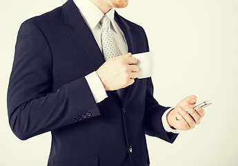 Image showing man with smartphone and cup of coffee