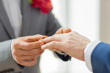 Image showing close up of male gay couple hands and wedding ring