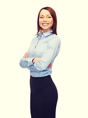 Image showing smiling businesswoman with crossed arms