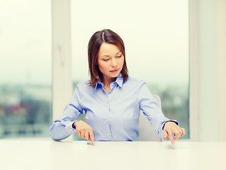 Image showing smiling woman pointing to something imaginary