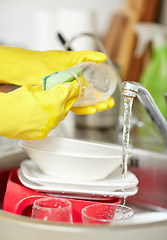 Image showing close up of woman hands washing dishes in kitchen