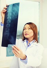Image showing concentrated doctor looking at x-ray
