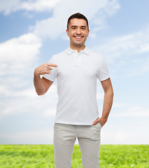 Image showing smiling man in t-shirt pointing finger on himself