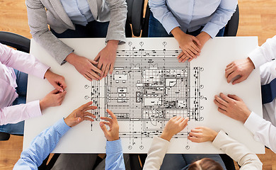 Image showing close up of business group with blueprint