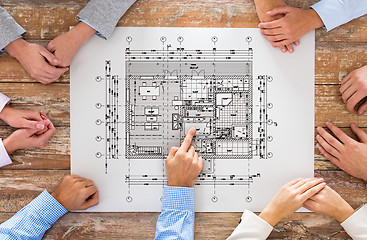 Image showing close up of business group with blueprint