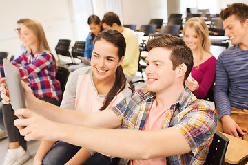 Image showing group of smiling students with tablet pc