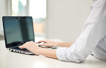 Image showing close up of woman typing on laptop at office