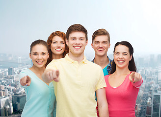 Image showing group of smiling teenagers over city background