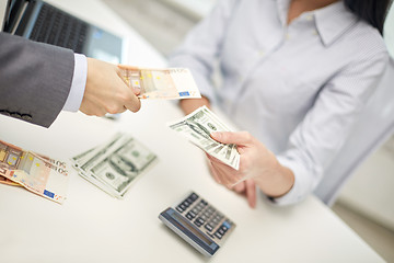 Image showing close up of hands giving or exchanging money