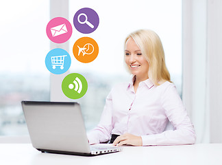 Image showing smiling businesswoman or student with laptop