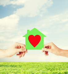 Image showing couple hands holding green paper house