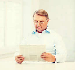 Image showing old man at home reading newspaper