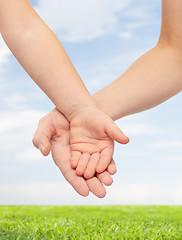 Image showing close up of woman and little child hands together