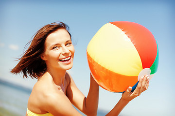 Image showing girl in bikini playing ball on the beach