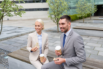 Image showing smiling businessmen with paper cups outdoors