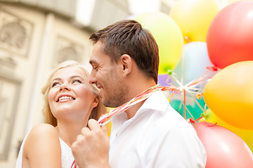 Image showing happy couple with colorful balloons