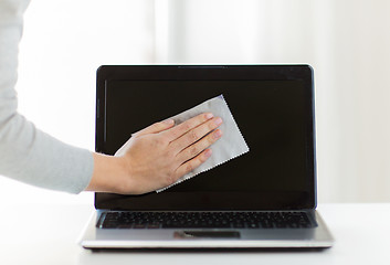 Image showing close up of woman hand cleaning laptop screen