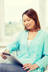 Image showing happy woman with tablet pc computer at home