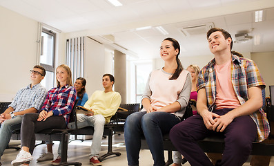 Image showing group of smiling students in lecture hall