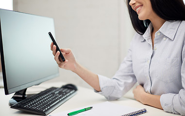 Image showing close up of woman texting on smartphone at office