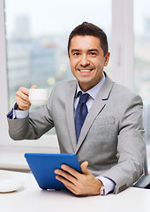 Image showing smiling businessman with tablet pc and coffee cup