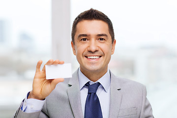 Image showing smiling businessman in suit showing visiting card