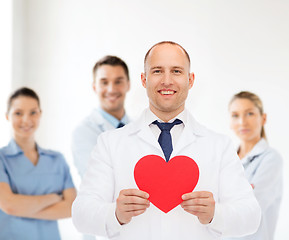 Image showing smiling male doctor with red heart