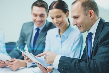 Image showing business team with tablet pc having discussion