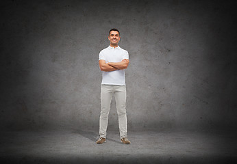 Image showing smiling man in white t-shirt with crossed arms