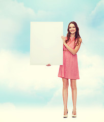 Image showing young woman in dress with white blank board