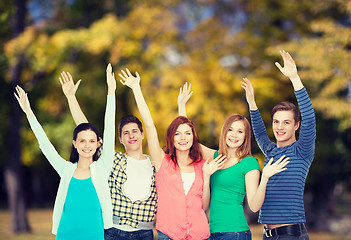 Image showing group of smiling students waving hands