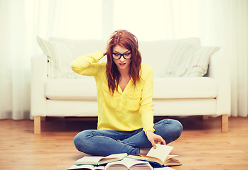 Image showing stressed student girl reading books at home