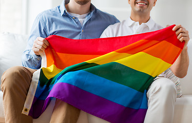 Image showing close up of male gay couple holding rainbow flag