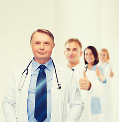 Image showing smiling doctor or professor with stethoscope