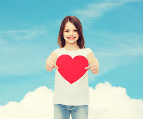 Image showing beautiful little girl sitting at table