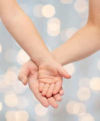 Image showing close up of woman and little child hands together