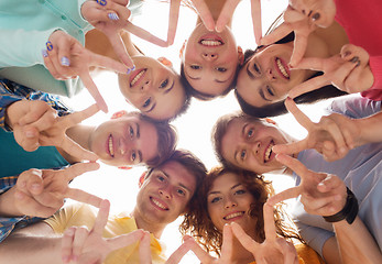 Image showing group of smiling teenagers showing victory sign