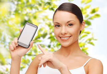 Image showing happy woman showing smartphone blank screen