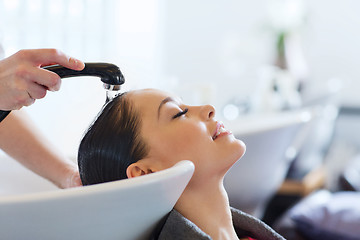 Image showing happy young woman at hair salon