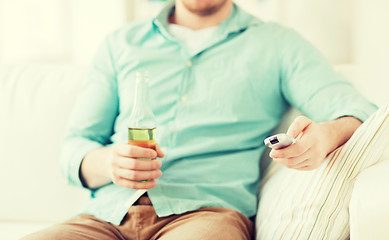 Image showing man with beer and remote control at home