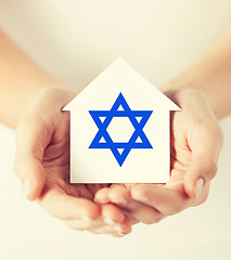 Image showing hands holding house with star of david