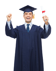 Image showing smiling adult student in mortarboard with diploma