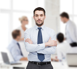 Image showing handsome businessman with crossed arms